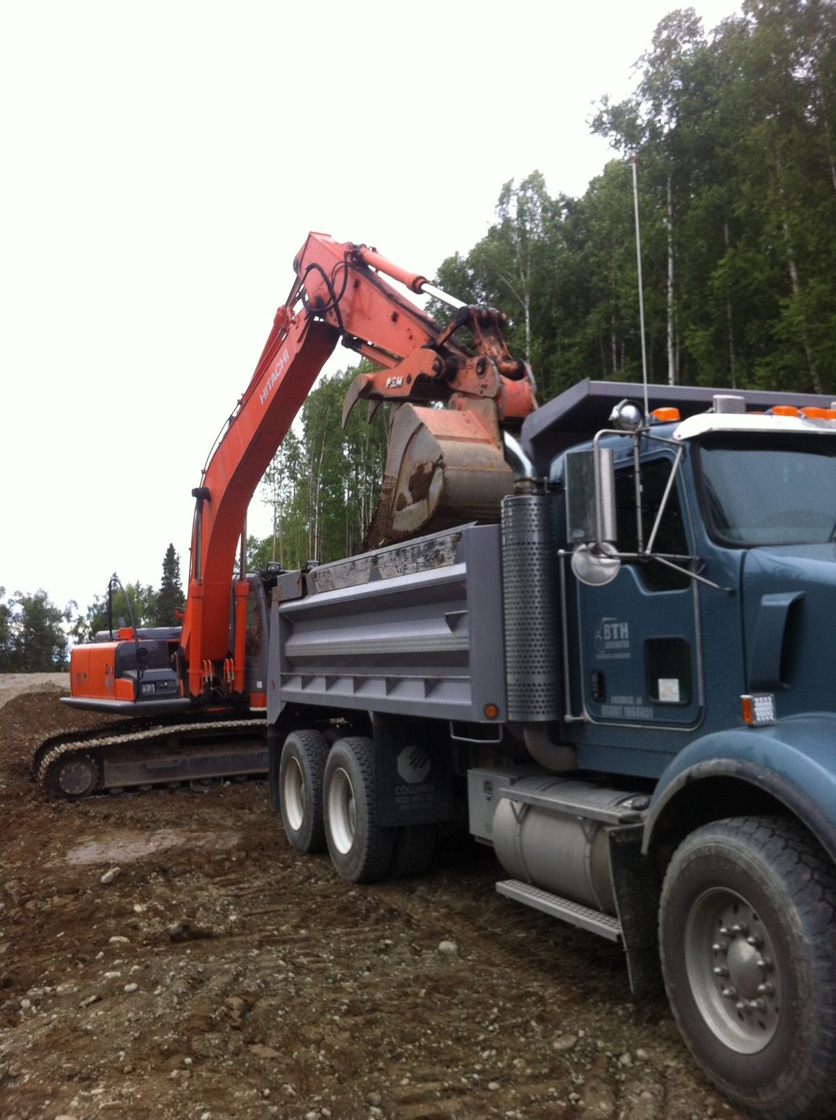 BTH Construction Hitachi excavator loading truck at Ketchum Heights Big Lake Alaska